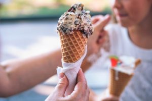 Two people holding ice cream cones