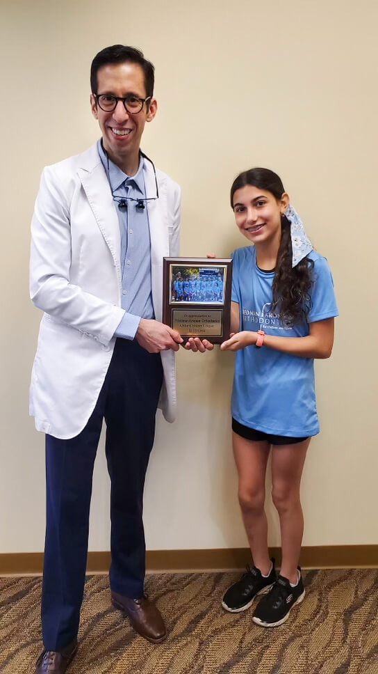 Oxford girls soccer player in braces with her favorite orthodontist, Dr. Ross Aronson