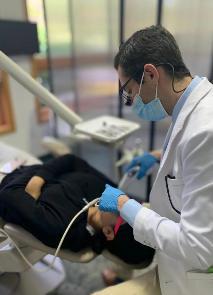 Dr. Ross Aronson working on a braces patient in his orthodontic clinic.