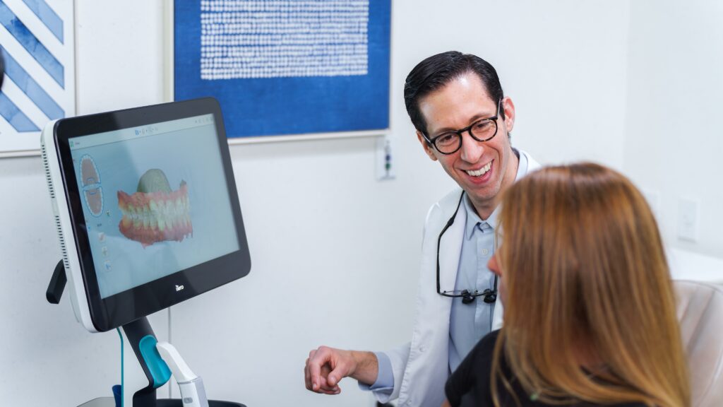 Dr. Aronson reviews a 3D scan with an orthodontic patient from his clean and welcoming office.