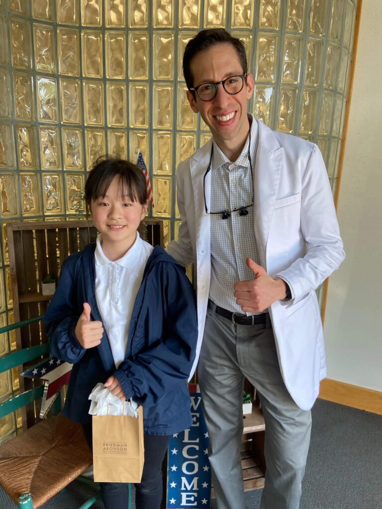 Dr. Ross Aronson with a happy braces patient at the end of treatment