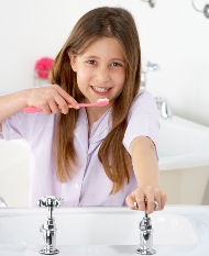 teen girl brushing teeth