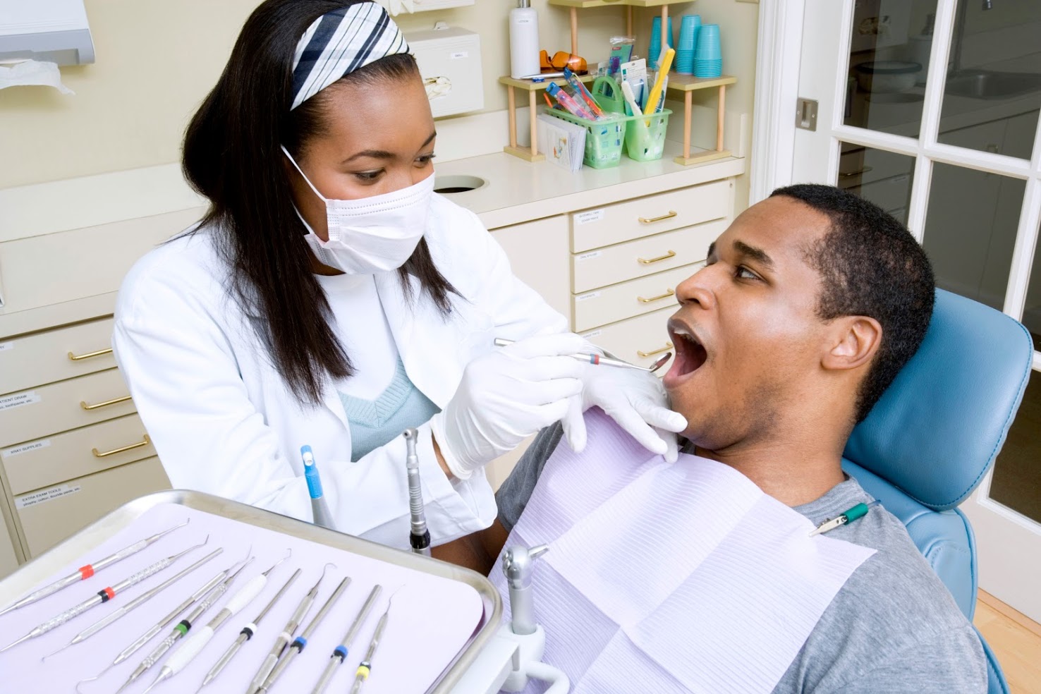 A man getting his teeth examined at the dentist