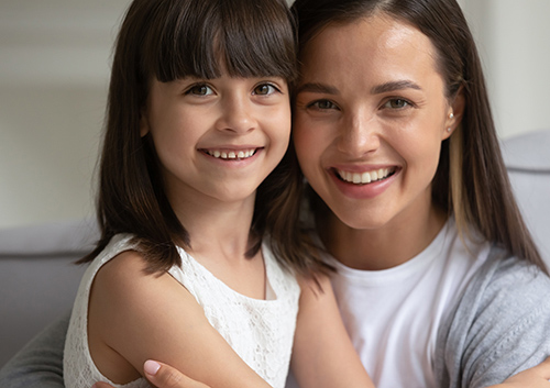 Happy mother after having a safe dental x-ray experience of her daughter in Worcester & Central, MA.