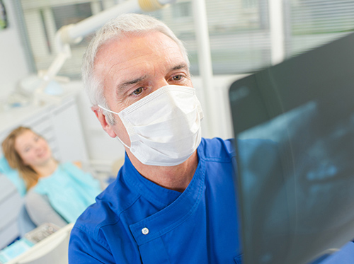 A doctor thoroughly examines the dental x-ray report of a patient in Worcester & Central, MA.