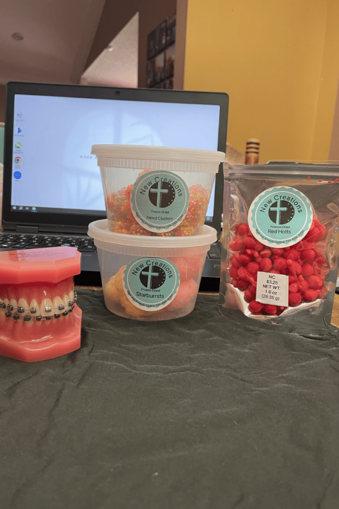 Freeze dried candy in containers with orthodontic braces model